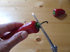Snip the stem from chiles for sriracha