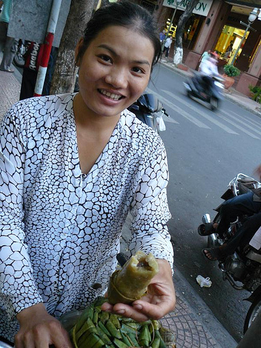 Street vendor selling bananas in sticky rice (banh tet chuoi)