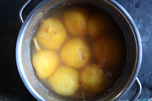 Poached peaches with ginger in pot