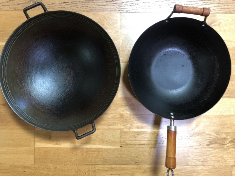 https://www.vietworldkitchen.com/wp-content/uploads/2019/10/woks-3mon-old-round-bottom-cast-iron15yrold-carbon-steel.jpg