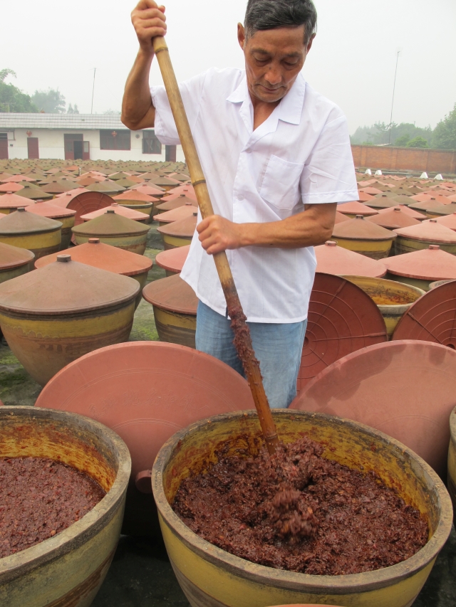 stirring doubanjiang in Pixian